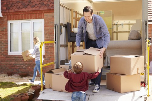 Trained moving staff handling boxes with care in Roehampton