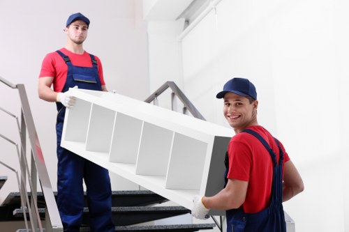 Furniture pick-up service in Roehampton removing a sofa from a residential home