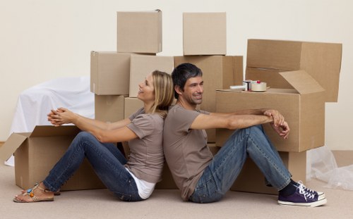 Professional movers loading items for transport in Roehampton