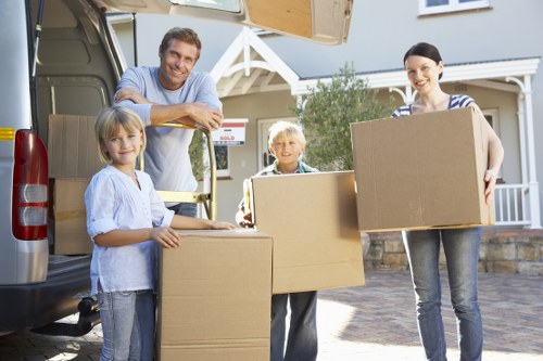 Professional movers handling office equipment in Roehampton