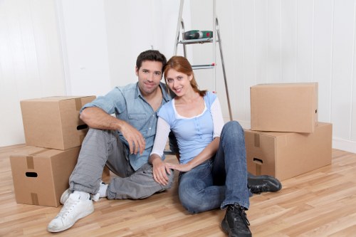 Prepared boxes and household items beside a moving truck in Roehampton