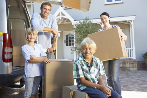 Removal specialists handling office equipment and desks