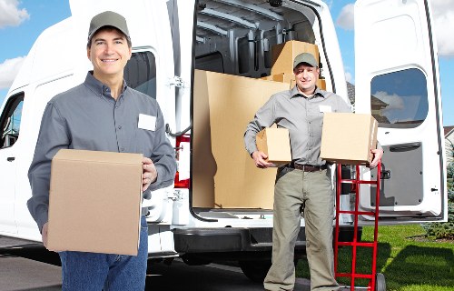 Moving team loading furniture into a removal van in Roehampton