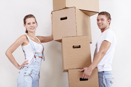 Local movers carrying furniture during a safe Roehampton home move